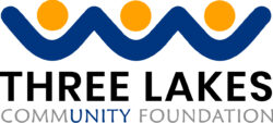 Three Lakes Community Foundation logo: a blue wavy line with three orange circles above, and bold black text 'THREE LAKES' with gray 'COMMUNITY FOUNDATION' beneath.